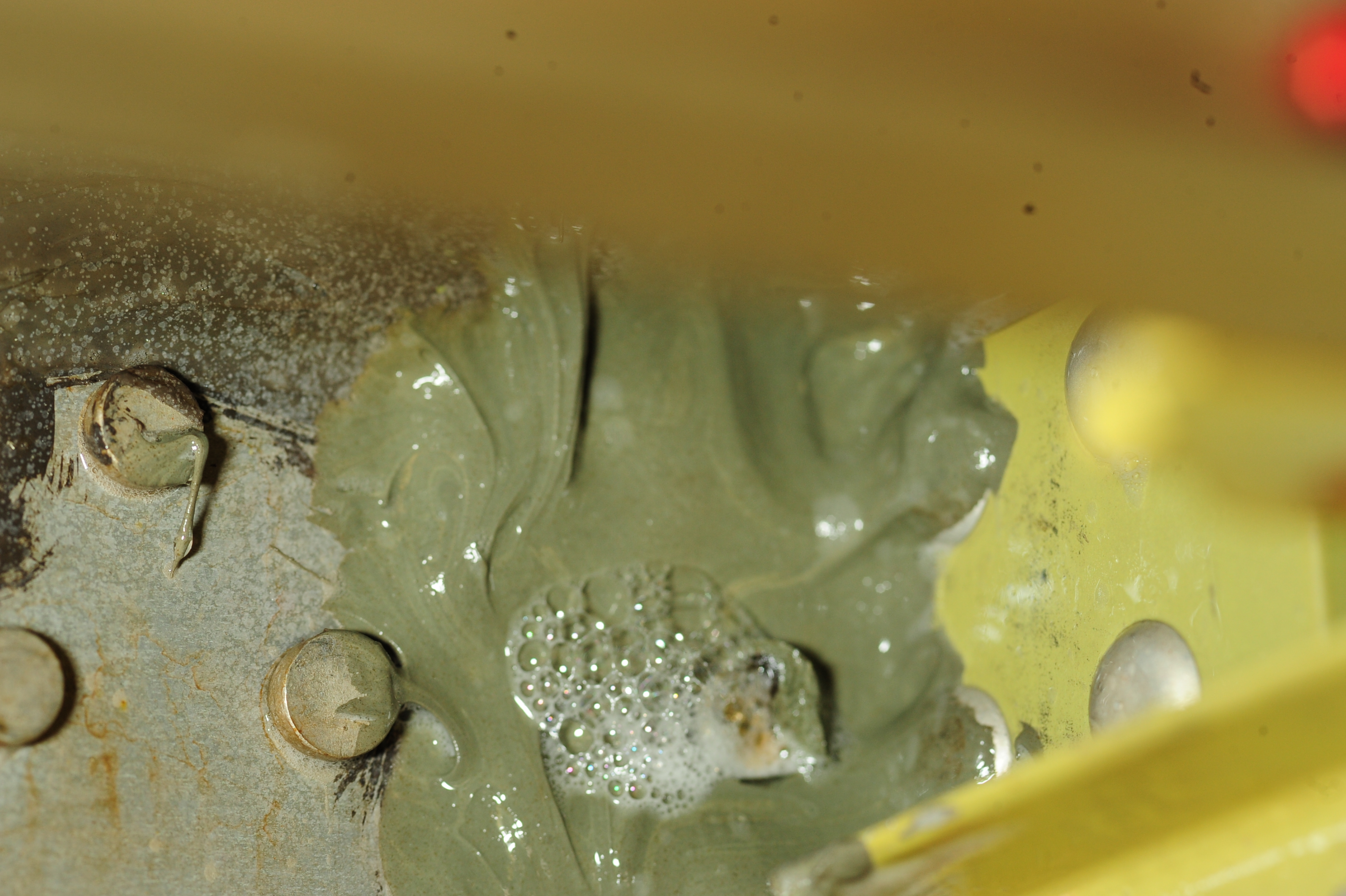 Technician applying advanced sealant to aircraft fuel tank interior to prevent leaks
